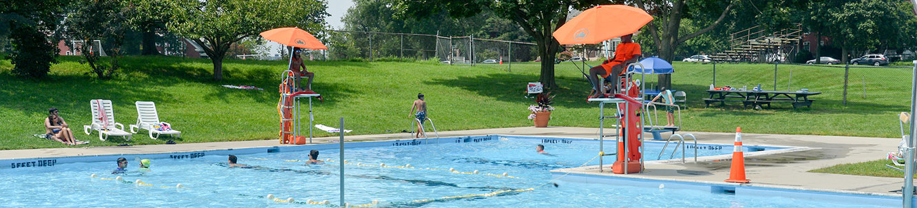 A pool set in a grassy field.