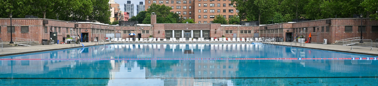 A massive outdoor public pool and recreation center complex in New York City.