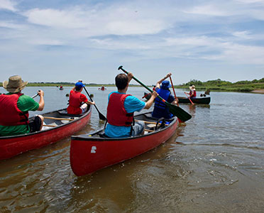Guests in canoe explore the park from on the water