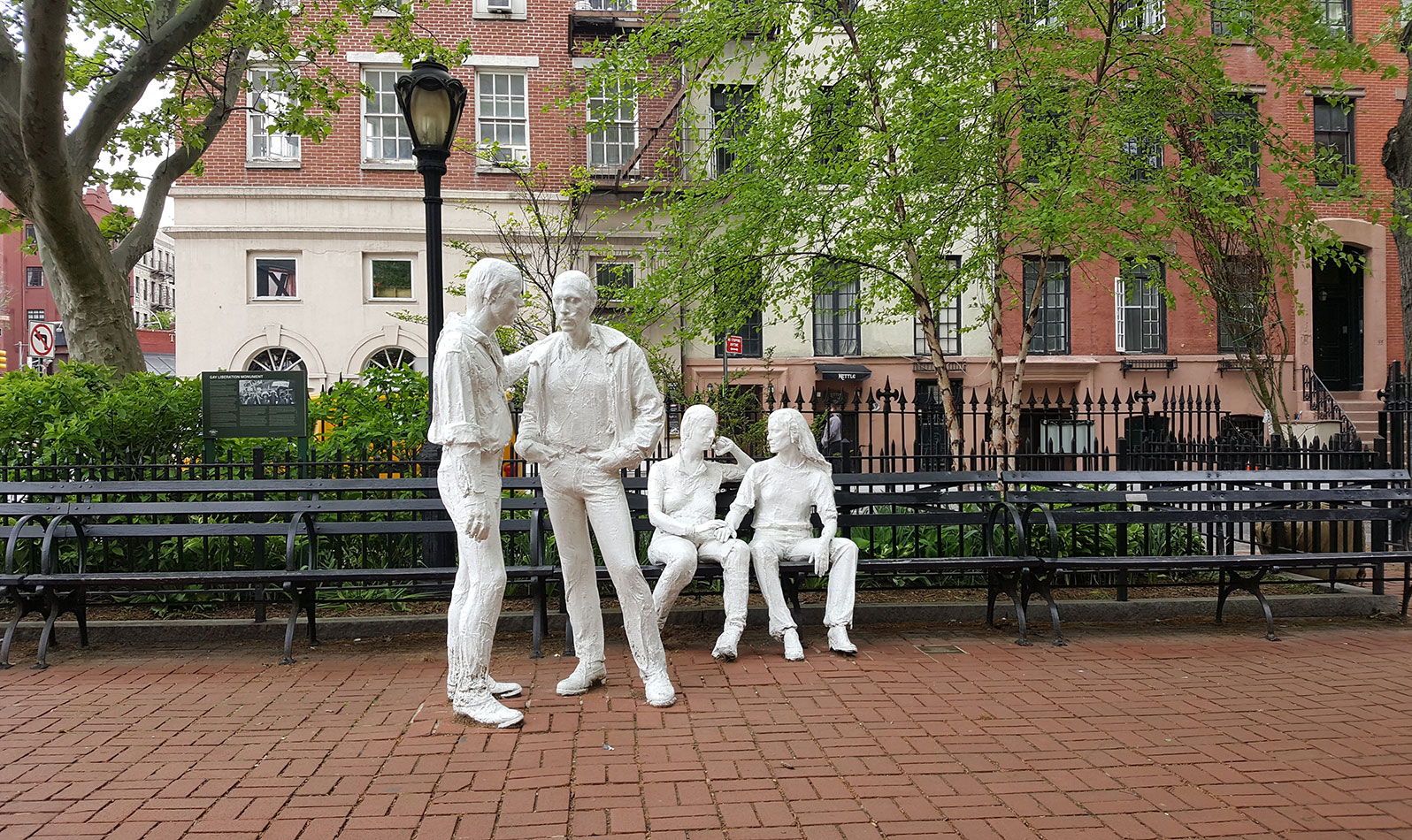 The Gay Liberation Monument, a historic LGBTQ site, features four figures - two standing males and two seated females - are positioned on the northern boundary of the park, in natural, easy poses. 