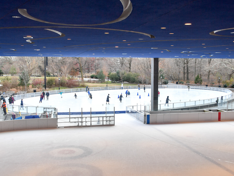 ice skaters enjoy the rink in the park