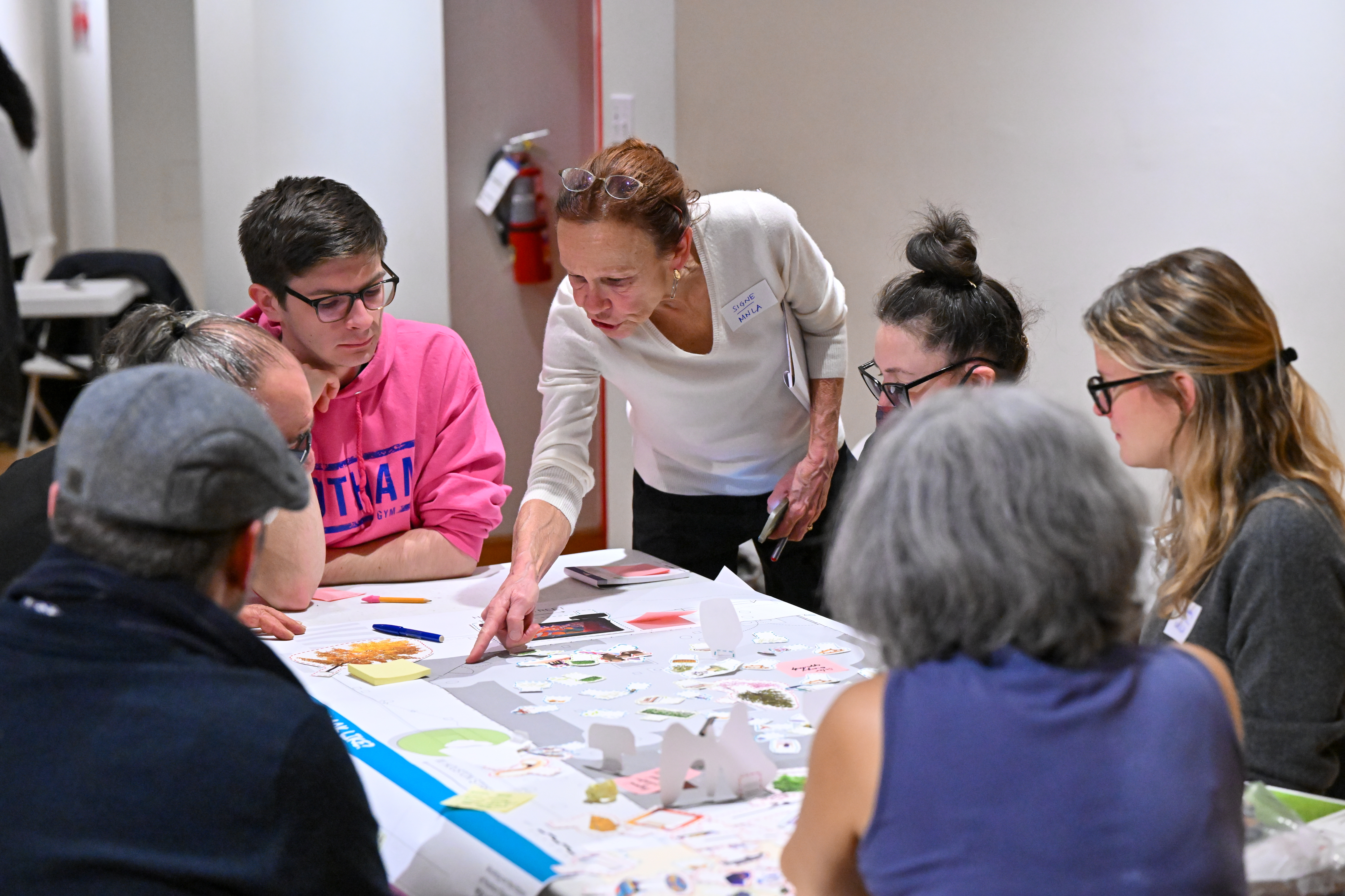 A group of people talking around a table.