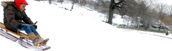 Child sledding down a hill