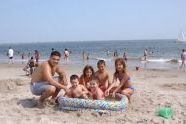 Family with portable pool at the beach 