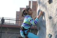 Scaling the rock climbing wall 