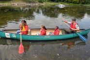 An Urban Park Ranger leads a canoe of children 