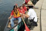 An Urban Park Ranger assists children eager to canoe the restored lake 