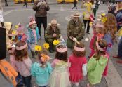 Children, adorned in flowers, gather around Urban Park Rangers 