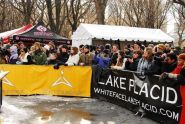 Spectators and press watch the snowboarders 